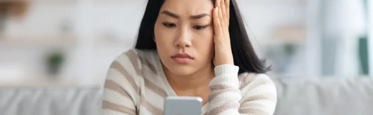 Young female confused looking at mobile